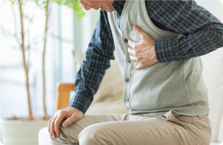 Man clutching chest, showing signs of possible chest pain