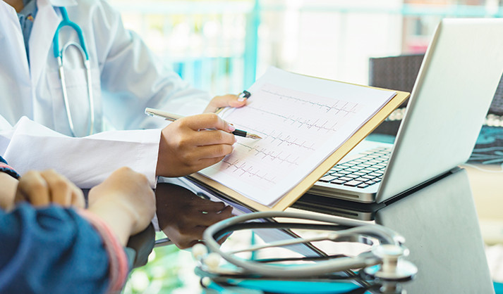 The doctor is explaining the patient’s heart rate to them due to arrhythmia