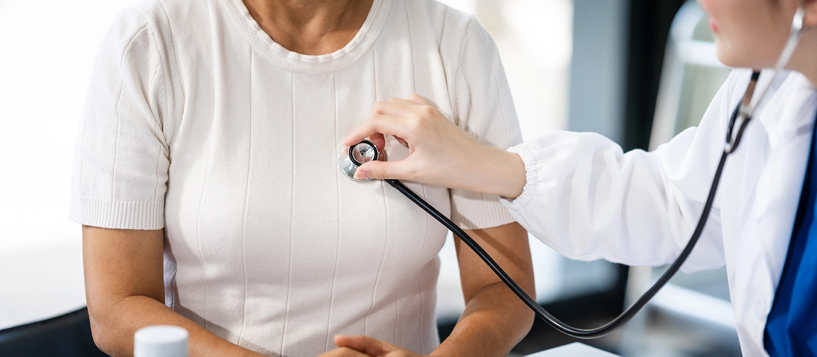 A doctor measuring a patient's heart rate
