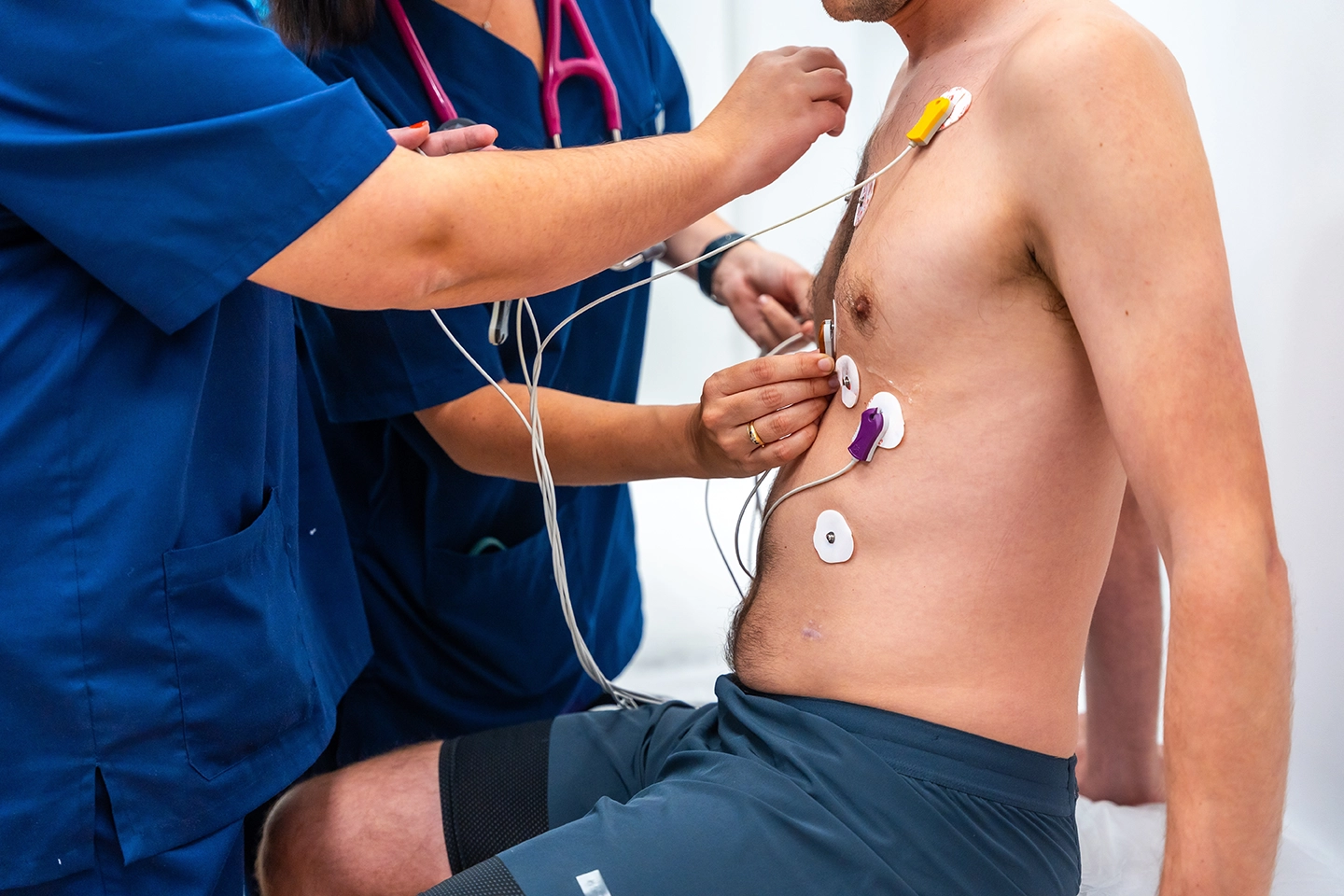 A doctor carrying out a cardiology assessment on a patient at a clinic