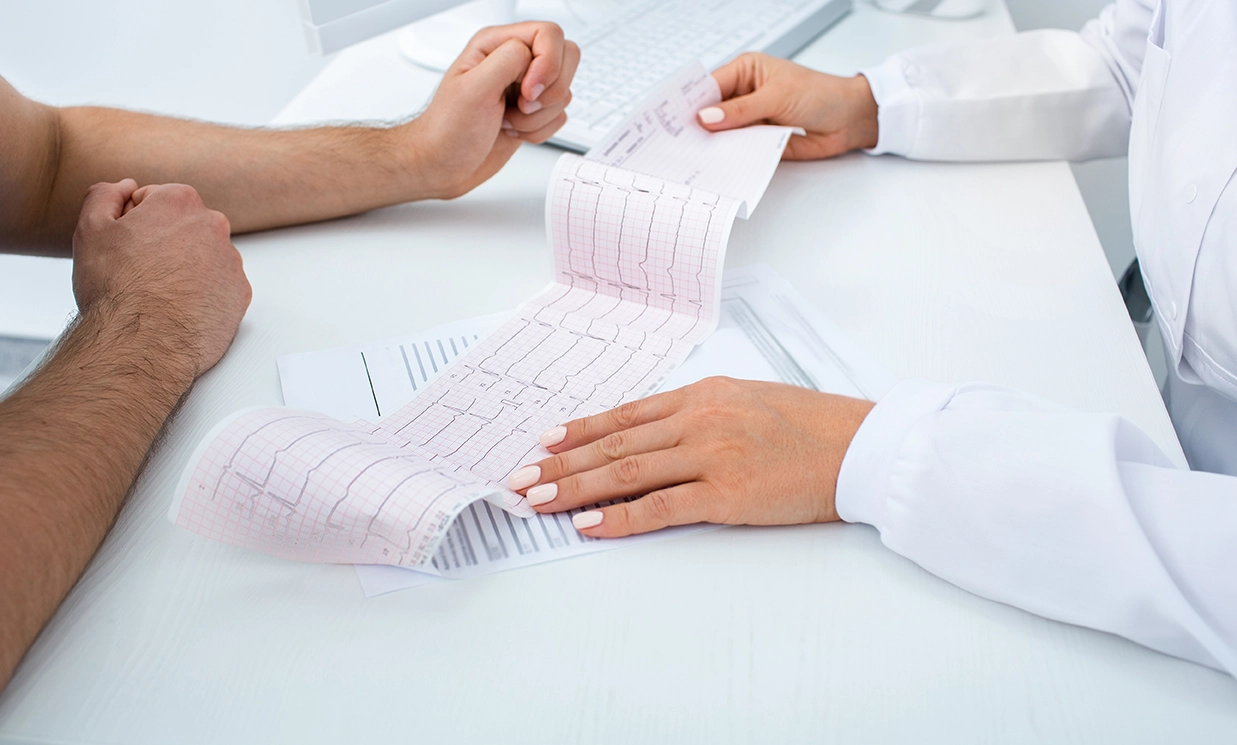 A heart specialist reviewing the results of a heart assessment with a patient