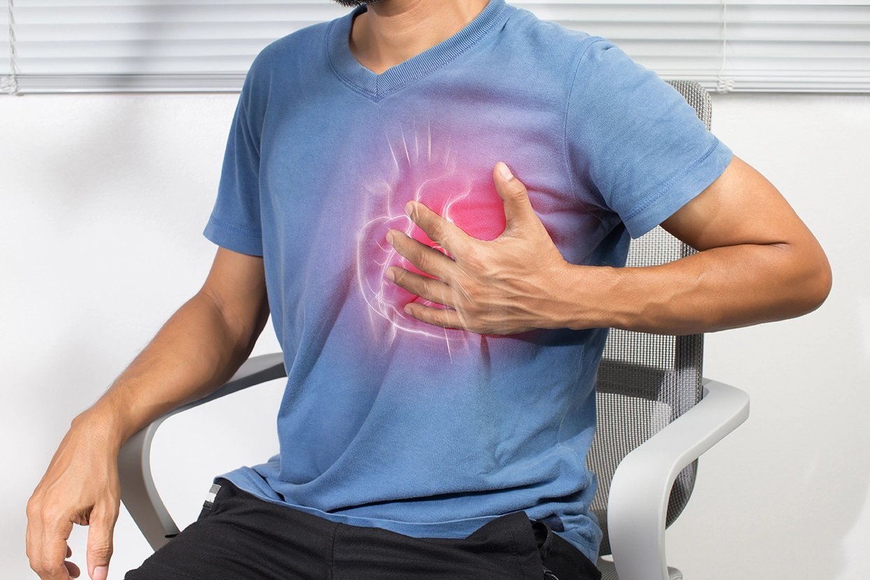 A man experiencing discomfort and chest tightness due to arrhythmia