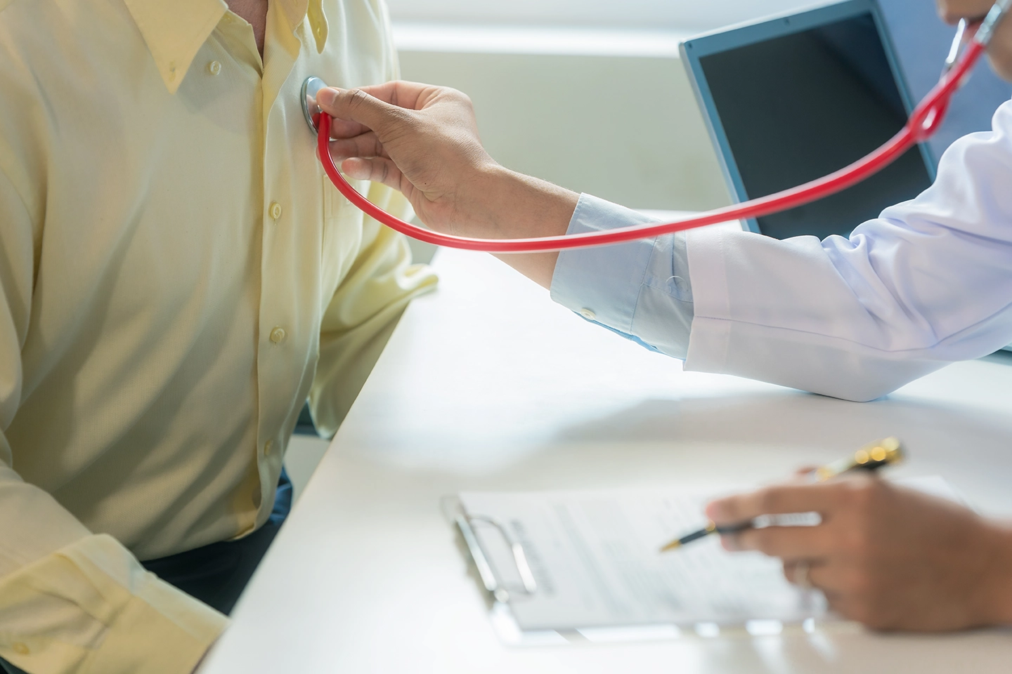 A doctor measuring a patient's heart rate