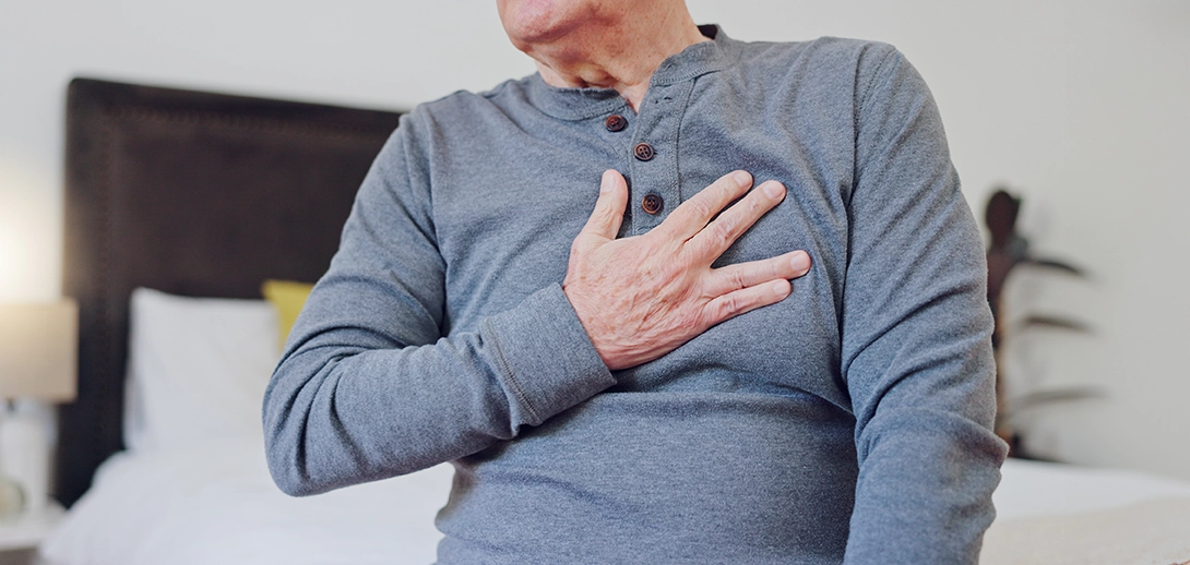 Zoom on elderly man with his hand on his chest over his heart
