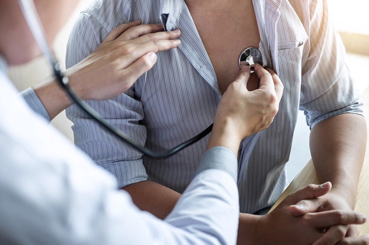Doctor using a stethoscope to examine a patient